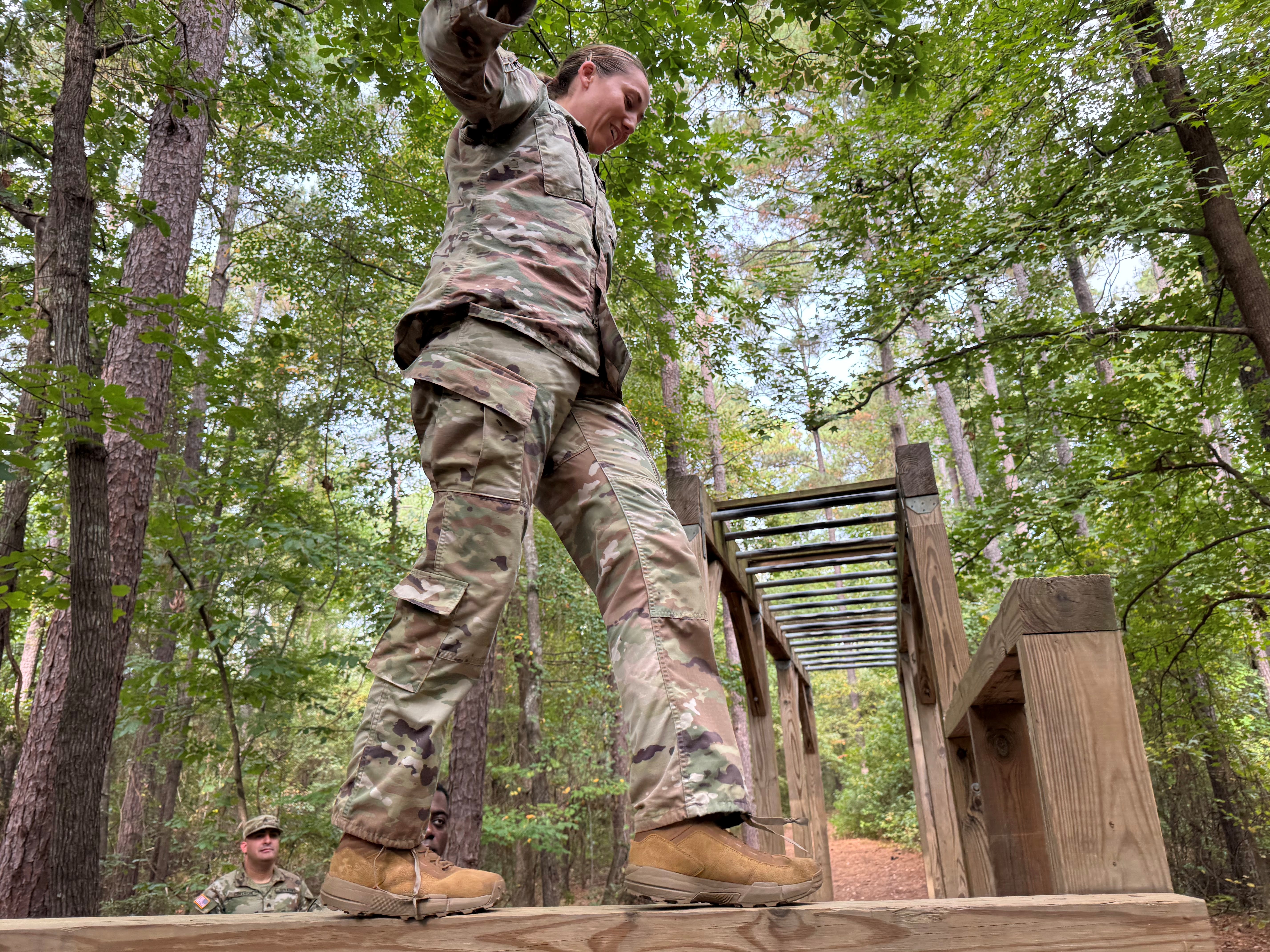 CPT Miller traversing the balance beams at the All American Mile Obstacle Course  Photo Credit: SPC Tremamunno